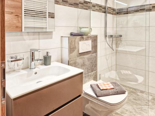 a bathroom with a sink and a toilet and a shower at Appartements & Chalets Wiesenruh in Bichlbach