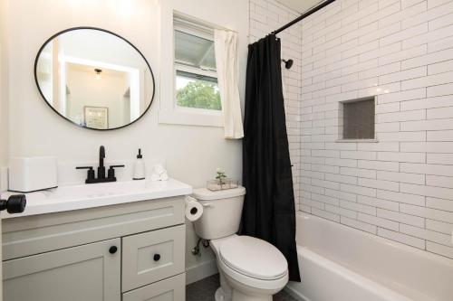 a bathroom with a toilet and a sink and a mirror at Cozy Apartment in Atwater Village in Glendale