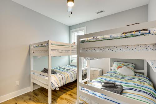 a bedroom with two bunk beds in a room at Oak Island Fall Getaway Coastal Home and Deck in Oak Island