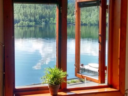 an open window with a view of a lake at Tärnaby Rooms & Apartments in Tärnaby