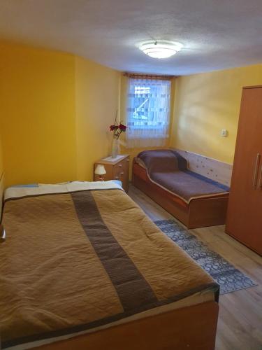 a bedroom with a large bed and a couch at Pokoje Gościnne Barbara in Ustroń