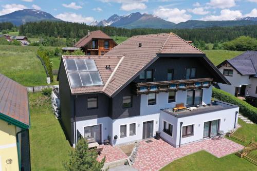 an aerial view of a house with a solar roof at FeWo HansUndChrista in Mariapfarr