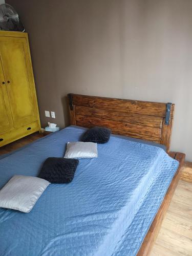 a bedroom with a blue bed with two pillows at Bulvár apartmán in Žilina