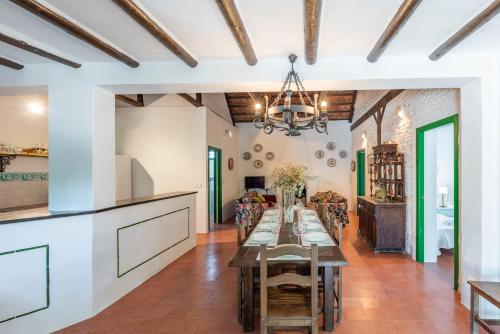 a kitchen and dining room with a table and chairs at Huerta la Pimentada in Palma del Río