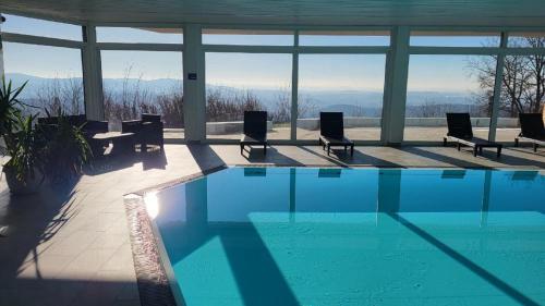 a swimming pool with chairs and a view of the mountains at Ferienwohnung Gipfelblick in Freyung