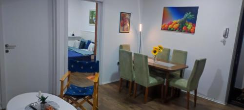 a dining room with a table and chairs and a table and a dining room at Apartments Vladika - Oldtown in Novi Sad