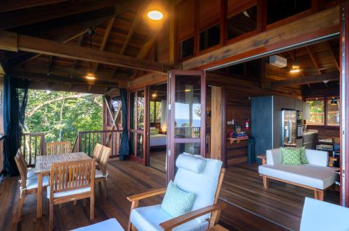 a porch of a house with a table and chairs at Secret Bay in Portsmouth