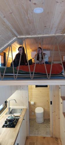 two people sitting on a bunk bed in a room at UnwindCabin Sohl in Bad Laasphe