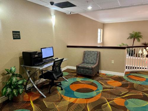 an office with a desk and a computer and a chair at Quality Inn & Suites Near University in Waco