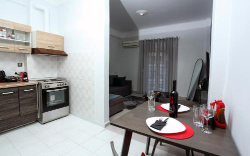 een keuken met een tafel met een fles wijn erop bij Manu Skg Apartment in Thessaloniki