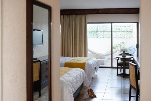 Ένα ή περισσότερα κρεβάτια σε δωμάτιο στο Hotel Los Aluxes
