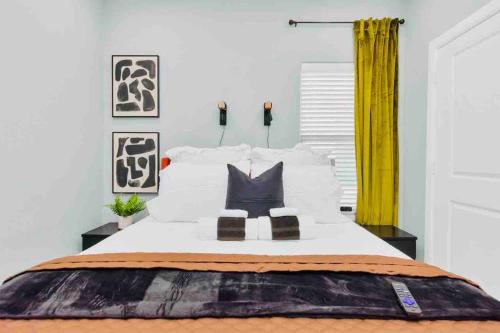 a bedroom with a large bed with yellow curtains at CAMP OUT - Big Backyard - 5mins To Downtown in Houston