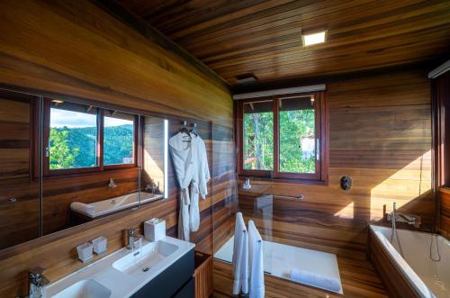 a bathroom with two sinks and a mirror at Secret Bay in Portsmouth