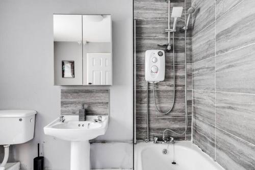 a bathroom with a shower and a sink and a toilet at City Links-3Bdrm terraced House-Parking-Antonio st in Liverpool