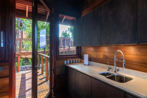 a kitchen with a sink and a large window at Secret Bay in Portsmouth