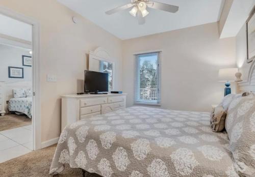a bedroom with a bed and a flat screen tv at Sterling Shores in Destin