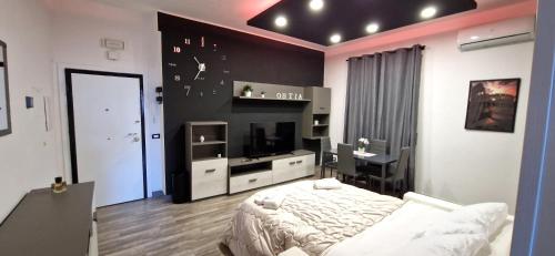 a bedroom with a bed and a desk and a television at Il centro di Ostia (apartment) in Lido di Ostia