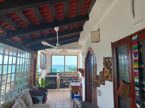 a living room with a view of the ocean at Casa Ana Ruth (Bucerias, Nay.) in Bucerías