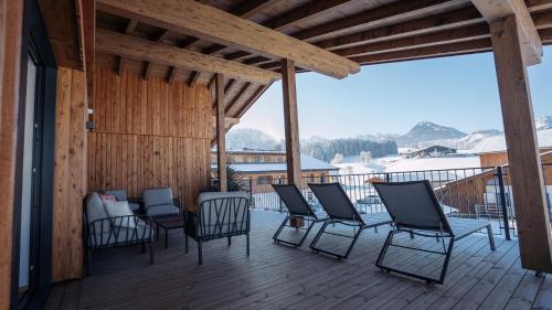 a group of chairs sitting on a deck at Feriengut Unterhochstätt in Schwendt