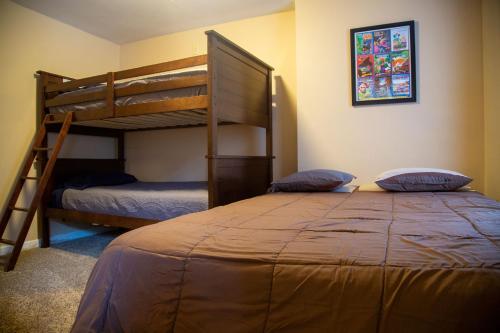 a bedroom with two bunk beds and a bed at The Maples - Hot tub! Amazing views, pets welcomed in Ellicottville