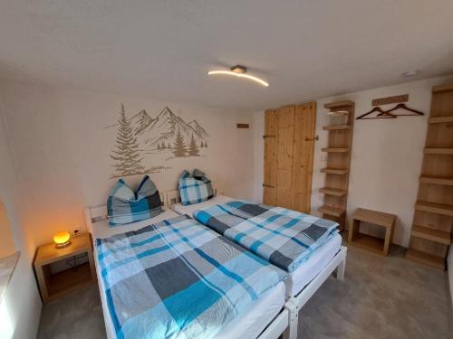 a bedroom with a bed with a mountain mural on the wall at Haus Gerda - Ferienwohnung 1 in Arnbruck