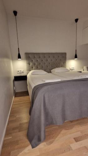 a bedroom with a large bed with two pillows at Silent apartment with balcony in Turku