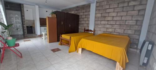 a room with a table with a yellow table cloth on it at Alto Bustamante in San Salvador de Jujuy