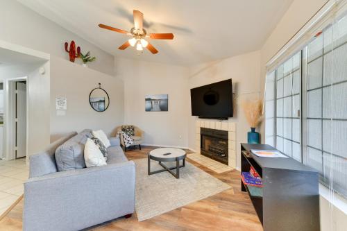 a living room with a couch and a ceiling fan at 7 Mi to Dtwn Chandler Pet-Friendly Condo with Pool in Chandler