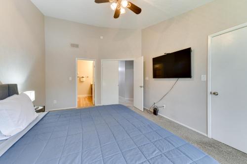 a bedroom with a bed and a flat screen tv at 7 Mi to Dtwn Chandler Pet-Friendly Condo with Pool in Chandler