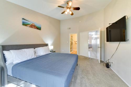 a bedroom with a blue bed and a ceiling fan at Pet-Friendly Condo with Pool about 7 Mi to Dtwn Chandler in Chandler