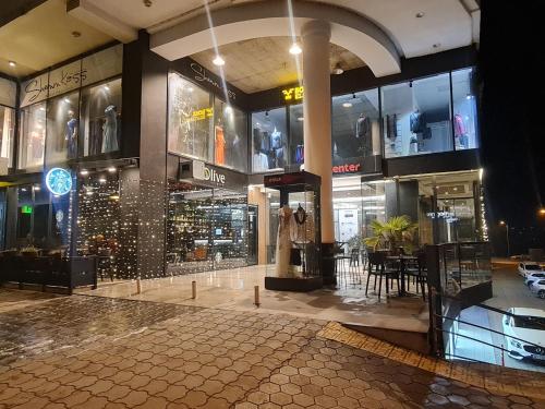 a shopping mall with a lot of glass windows at Apartment 06 in Gjilan
