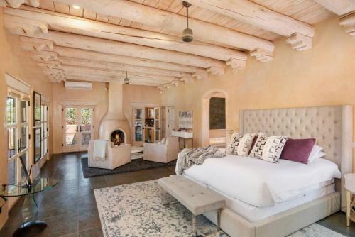 a bedroom with a large bed and a fireplace at Villa Namaste-Mountain View Home in Santa Fe