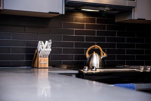 a tea kettle sitting on a stove in a kitchen at Revelstoke Marvel - Two Bedroom with Hot Tub in Revelstoke