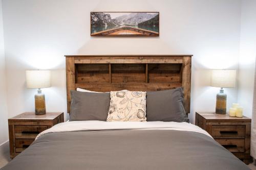 a bedroom with a large bed with two night stands at Revelstoke Marvel - Two Bedroom with Hot Tub in Revelstoke