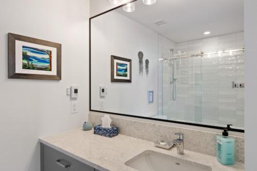 a bathroom with a sink and a shower at Ocean View Townhouse #26 at THE BEACH HOUSE in Campbell River