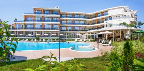 a resort with a swimming pool and a building at Hotel Miramar Sozopol in Sozopol