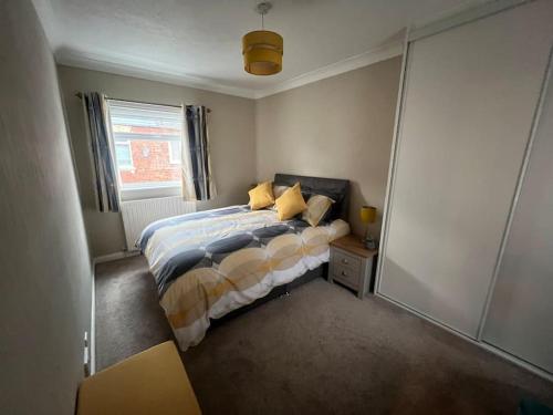 a small bedroom with a bed and a window at Stylish & Centrally Located in Chester-le-Street