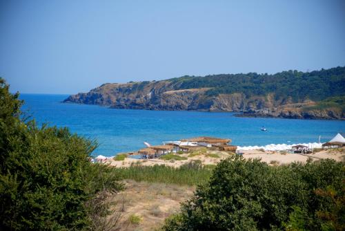 a beach with a group of houses and the ocean at Hotel Miramar Sozopol in Sozopol