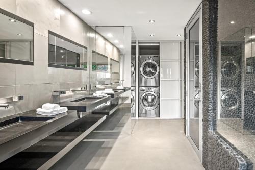 a bathroom with multiple sinks and washing machines at Hollywood Hills Luxury Modern Home with Pool & Sunset views in Los Angeles