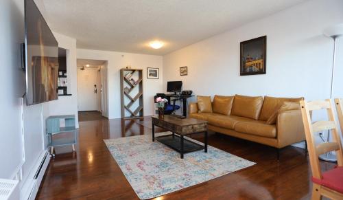 a living room with a couch and a table at Cambridge 2 BR king gym Near Uni RUH City H in Saskatoon