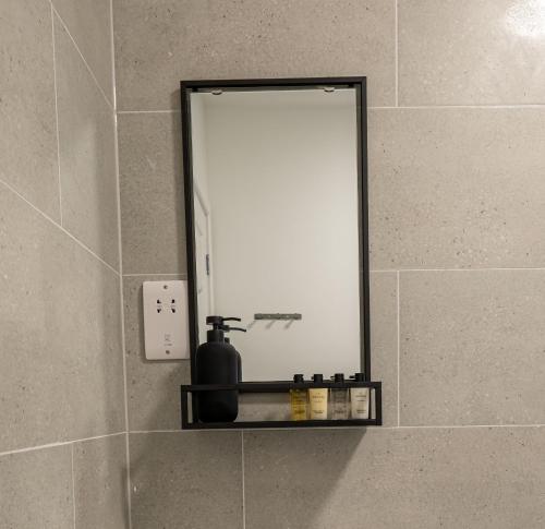 a mirror on a wall in a bathroom at Western House, Sleeps 5, Free parking, Longer stay savings in Reading