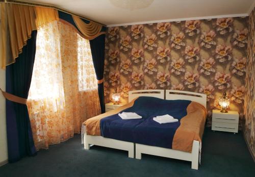 Кровать или кровати в номере Бутик-отель «Три Богатыря»