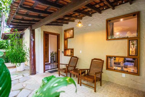 a patio with chairs and a table and a mirror at Pousada Cavaleiro dos Pireneus in Pirenópolis