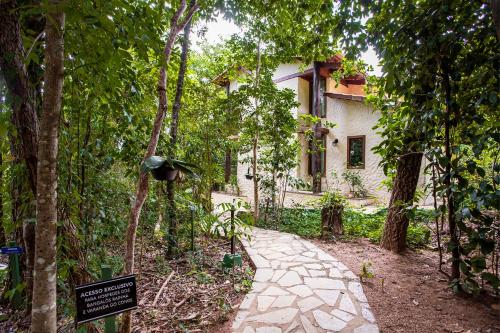 a walkway in front of a house with trees at Pousada Cavaleiro dos Pireneus in Pirenópolis