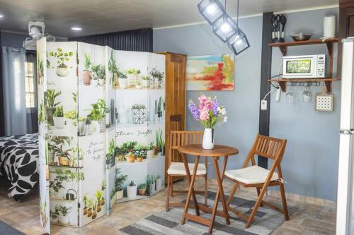 a room with a table and a plant wall at Dos Morenas Apartments - Apt 3 in Bajo Boquete