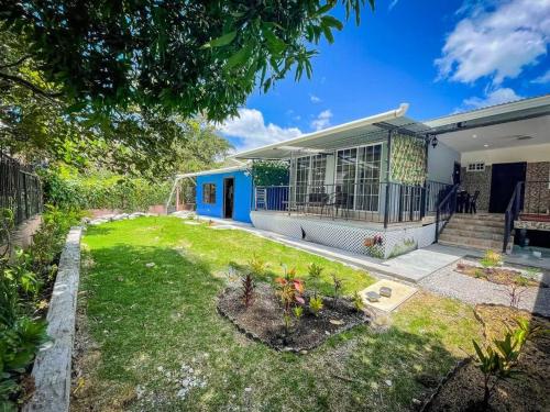 a house with a garden in front of it at Dos Morenas Apartments - Apt 3 in Bajo Boquete