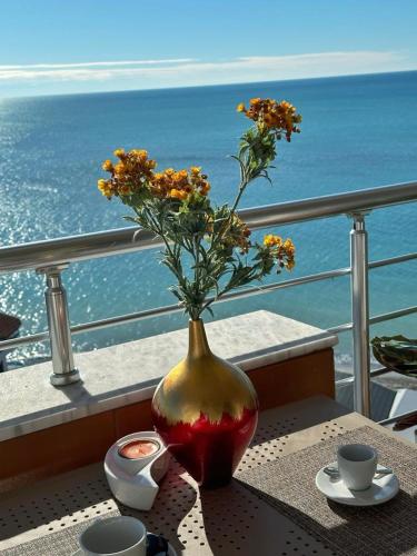 a vase with flowers in it sitting on a table at NOVA Sea View Apartments in Durrës