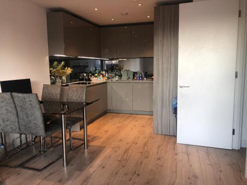 a kitchen and dining room with a table and chairs at Double Room in London
