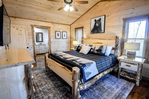 a bedroom with a bed in a wooden cabin at Black Bearry in Blue Ridge