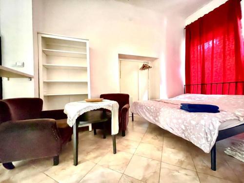 a bedroom with a bed and a table and chairs at Apartment Elizabeth 2 in Košice